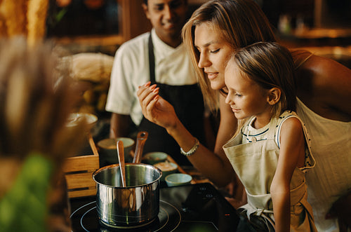Mother and child learning to cook during an interactive class on vacation