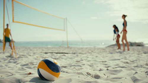 Wide shot of professional beach volleyball athletes warming up for the championship match