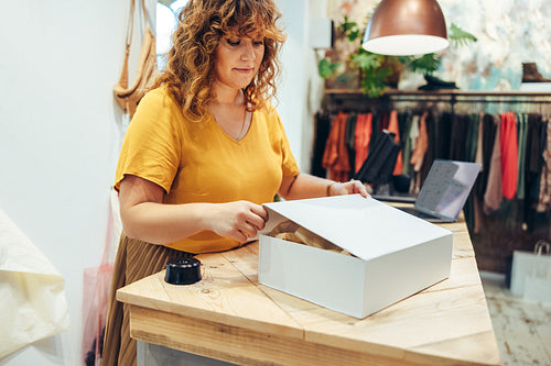 Woman packaging box for an online store