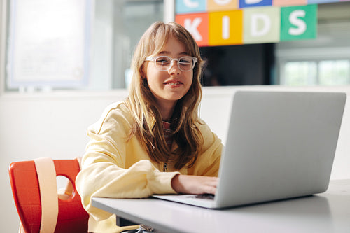 Young female student learning to programme in a computer science classroom
