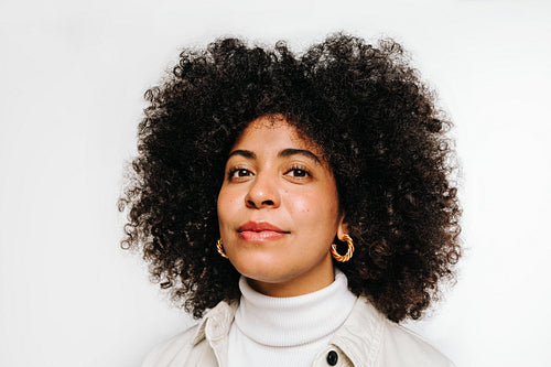 Portrait of a confident woman with curly hair looking at the camera