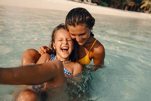 Tropical bonding: Sisters sharing joy and fun on a beach holiday