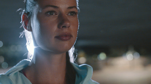 Fitness woman standing outdoor at night