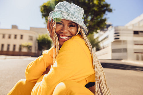 Cheerful young woman smiling outdoors
