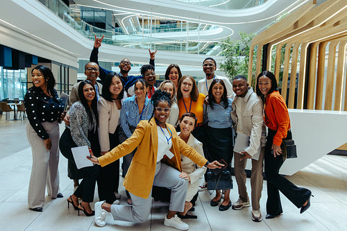 Diverse team posing cheerfully in a modern office environment