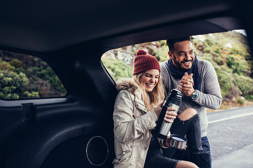 Couple having coffee break during road trip