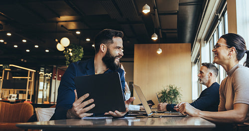 Co-workers smiling at each other in a co-working space