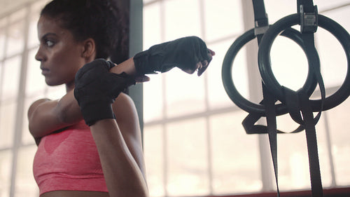 Strong woman stretching her arms at gym
