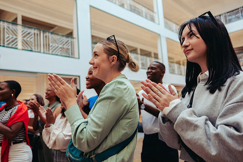 Group of diverse professionals applauding with appreciation during a corporate event