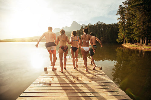 Friends about to jump into the lake