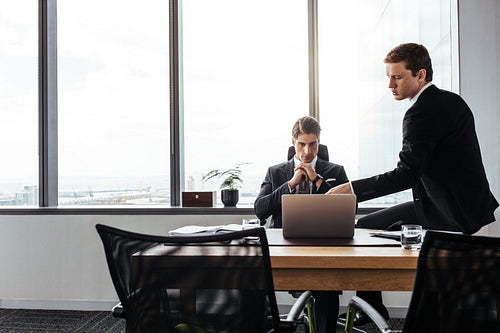 Corporate professionals working together at office desk