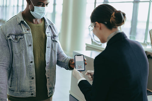 Airlines attendant checking medical pass during pandemic