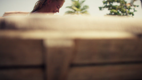 Family vacationing by a beautiful tropical pool on a sunny day at the resort