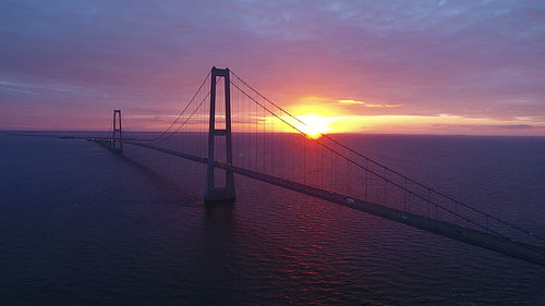 Suspension bridge on sea in Denmark at sunset