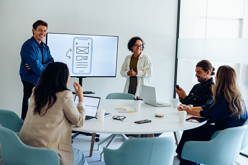 Team presents UX design ideas during a meeting