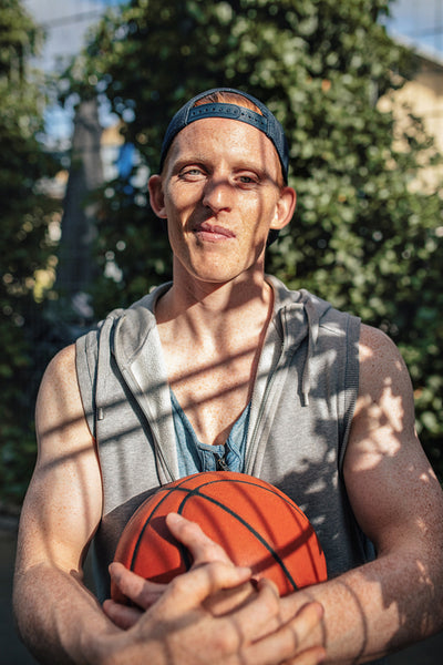Relaxed young man holding a basketball