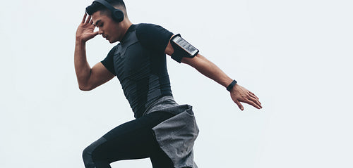 Fit asian man doing stretching workout