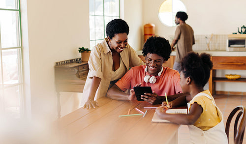 Happy family learning together at home using technology