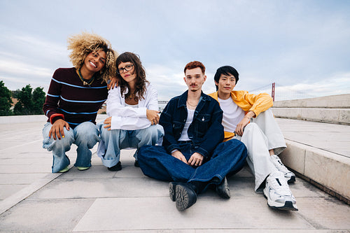 Diverse friends relaxing outdoors in an urban waterfront setting