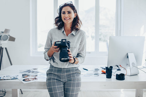 Photographer with a professional camera in office