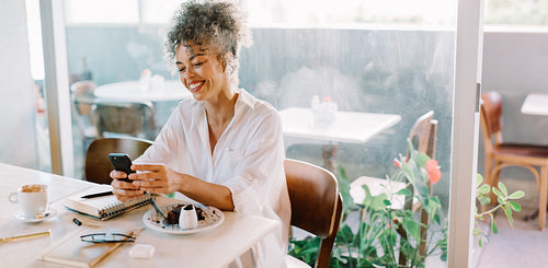 Happy businesswoman taking a video call in a cafe