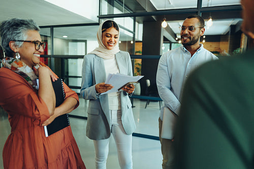 Happy businesspeople holding a staff meeting in a modern office