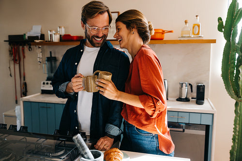 Couple enjoying coffee in modern kitchen