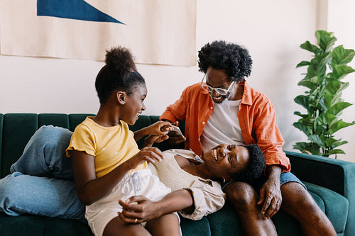 Family time: Parents and their daughter laughing and having fun together at home