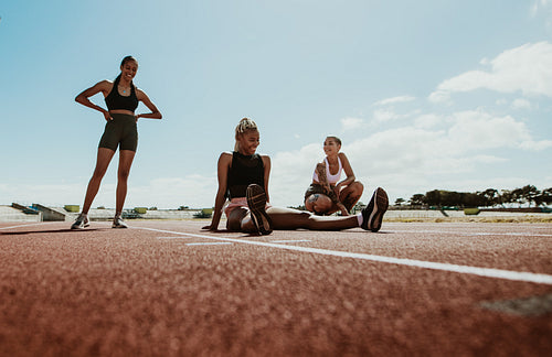 Group of female runners relaxing after workout