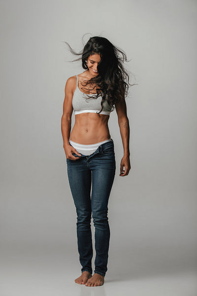 Pretty woman with unzipped pants and hair blowing