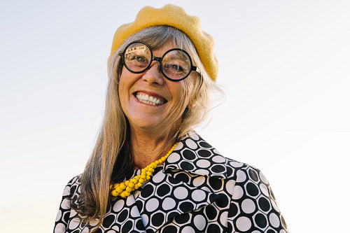 Cheerful senior woman smiling happily outdoors