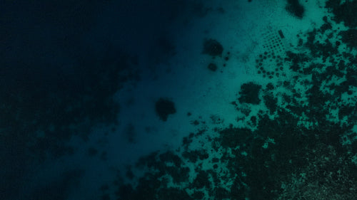 Small boat navigating clear ocean waters