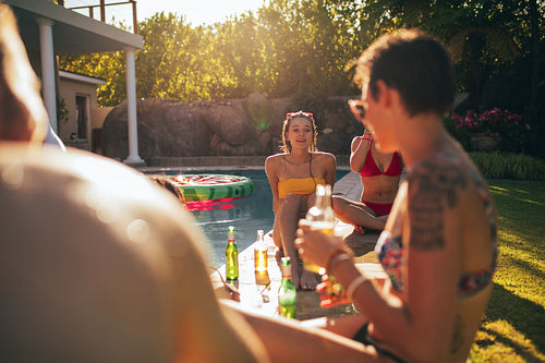 Multiracial friends enjoying at poolside party