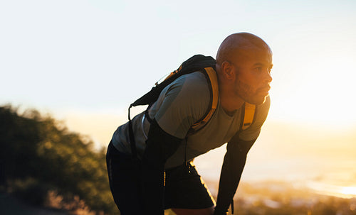 Mountain trail runner resting after a run