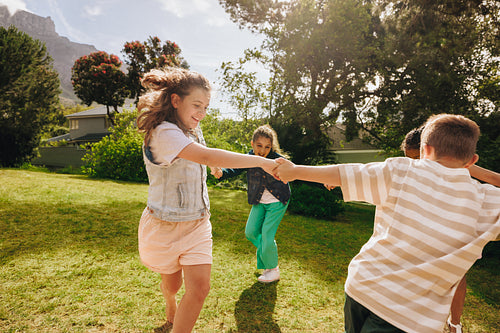 Children playing and enjoying their time outdoors in sunny green surroundings