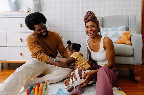 Happy family playtime with baby in living room