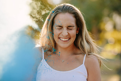 Portrait of a smiling woman playing holi