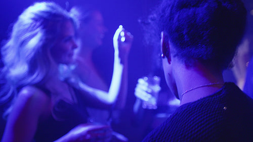 Beautiful woman dancing at disco with friends