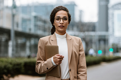 Confident businesswoman on city street