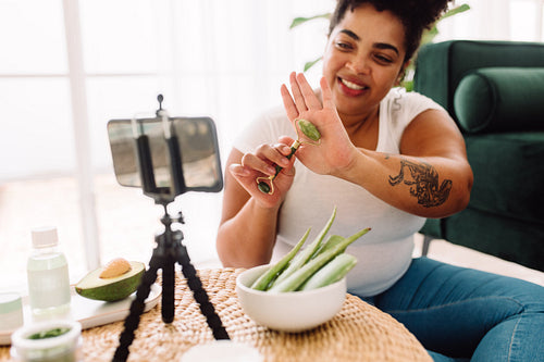 Woman showing beauty tool in vlog