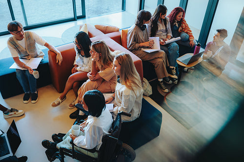 Diverse group of students studying and collaborating on campus in a vibrant and inclusive setting, fostering creativity and teamwork.