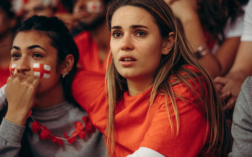 English soccer fans anxiously watching a game from stadium