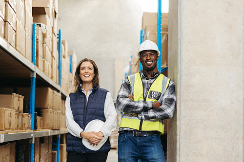 Happy warehouse workers smiling at the camera