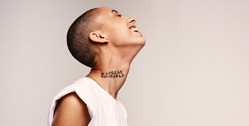 Cheerful woman with express yourself written on neck