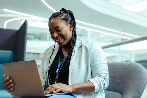 Confident female financial advisor working on a laptop in modern office