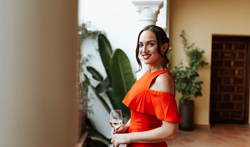 Happy young woman smiling while standing on a balcony