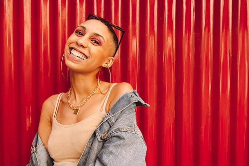 Happy young woman smiling at the camera cheerfully