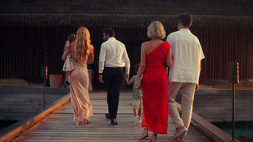 Vacationing family raise their glasses for a celebratory toast at an intimate dinner