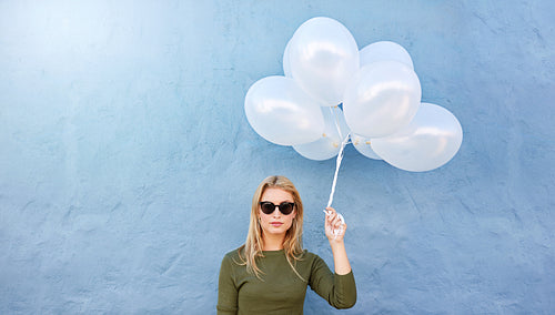 Young beautiful woman with white balloons