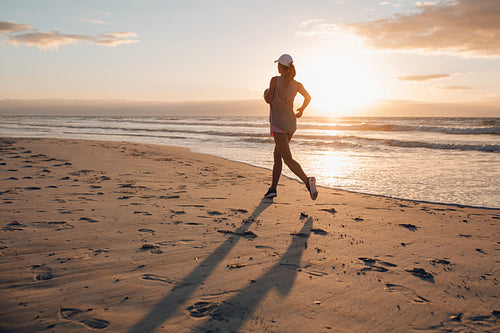 Young woman running on the beach